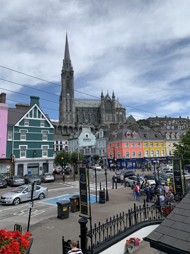 St. Colman’s Cathedral overlooking colorful houses in Cobh, Ireland.